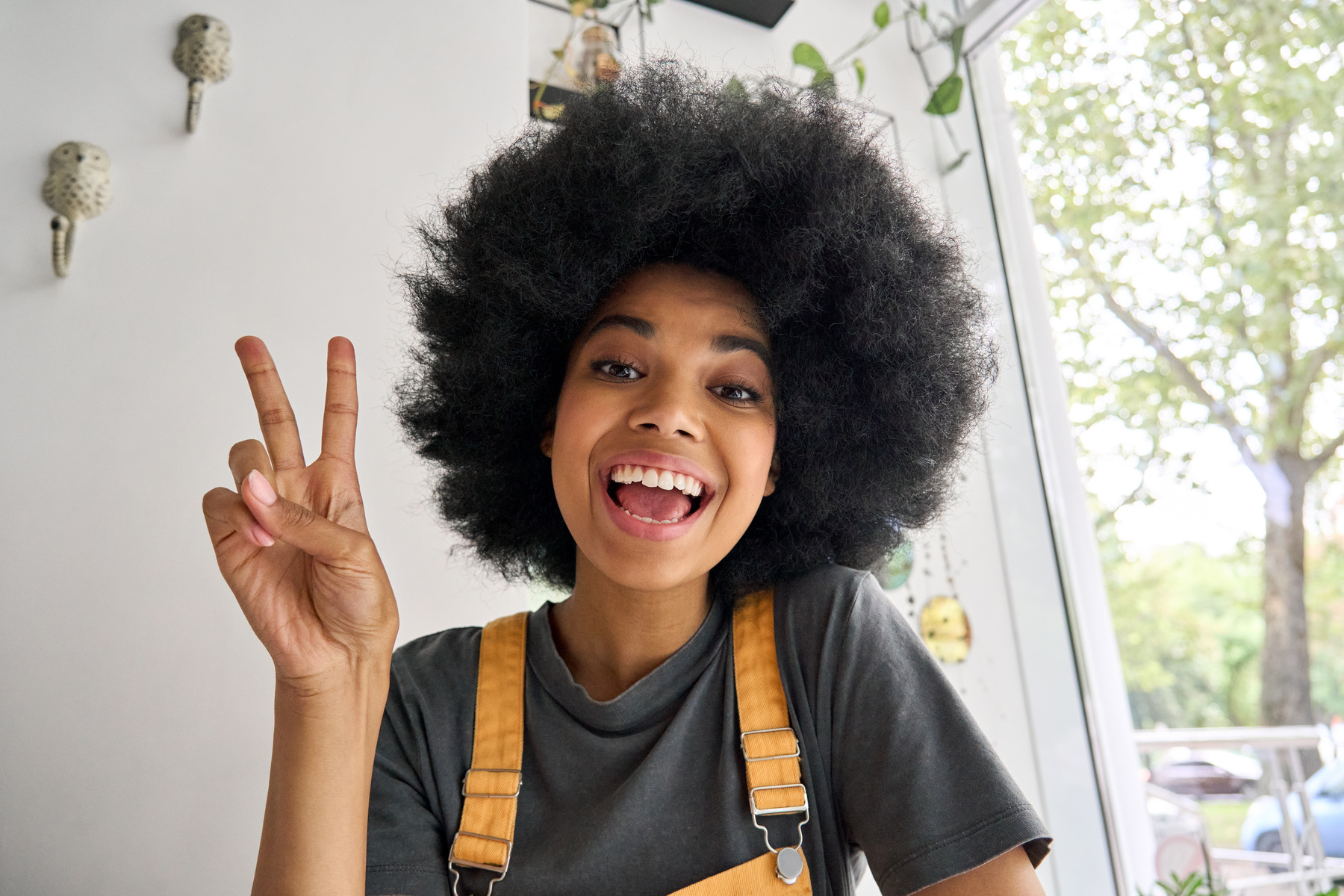 Portrait of a Young Woman Doing a Peace Sign